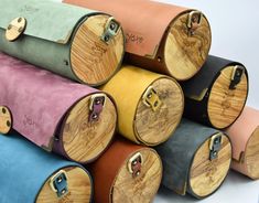 several different colored wooden barrels stacked on top of each other