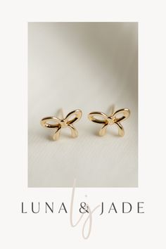 Experience the magic of Luna & Jade's Bow Studs – a stunning combination of elegance and fun. These versatile earrings make the perfect gift idea for any occasion, offering a touch of whimsy and charm to any outfit. Get ready to make an impression with these irresistible accessories. Shop Now! Gold Dainty Bow Earrings, Cute Gold Bow Earrings, Gold Dainty Earrings With Bow, Dainty Gold Earrings With Bow, Cute Anniversary Jewelry With Bow, Gold Earrings With Bow Tie Detail For Gift, Gold Bow Tie Earrings For Gift, Dainty Gold Bow Earrings, Cute Bow Earrings For Gifts