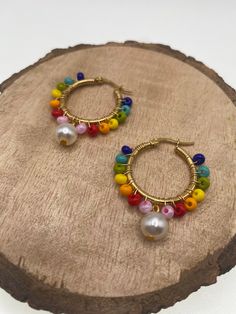 -Colorful hoop earrings that will spice up your looks! -Made with wire, Czech beads and pearls. -These Earrings are simple and yet so fun!  -Whether you're going for a casual or a dressy look, these earrings will add the perfect final touch to all your looks! CARE INSTRUCTIONS TIPS: -Avoid strong chemicals and water to keep them looking like new for much longer -Store away from other jewelry to avoid tangling or scratches -Clean with a soft, dry cloth SHIPPING: -  We are dedicated to ship your orders as soon as a possible.  -Most orders will be shipped out within the same day the order was placed.  -  Feel free to contact us if you need to rush your order, we are happy to accommodate.  -Free shipping on orders over $35 -Feel free to contact us for more details.   ADDITIONAL INFO: -An Origi Colorful Dangle Hoop Earrings As Gift, Multicolor Wire Wrapped Beaded Earrings As Gift, Multicolor Wire Wrapped Beaded Earrings For Gift, Colorful Dangle Hoop Earrings With Ear Wire, Colorful Dangle Hoop Earrings, Multicolor Hoop Earrings With Dangling Beads For Gift, Multicolor Hoop Earrings With Dangling Beads As Gift, Handmade Czech Glass Hoop Earrings Gift, Colorful Handmade Dangle Hoop Earrings