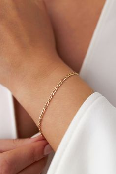 Our new simple and dainty Figaro chain bracelets, as always made in 14k solid gold. You can wear this bracelet with a free mind without worrying about water, perfume, or conditioner contact since real gold never tarnishes.★ Features of the Bracelet (this listing is for a single bracelet only)• Gold Kt: 14K Solid Gold (all pieces are stamped for authenticity)• Available Gold Color: Yellow Gold• Chain Width: 2.5 mm Single Bracelet, Solid Gold Bracelet, Water Perfume, About Water, Free Mind, Chain Bracelets, Figaro Chains, Figaro Chain, Yellow Gold Chain