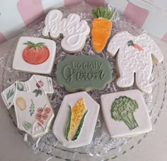 a glass plate with some decorated cookies on it