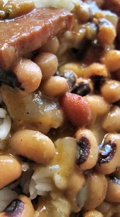 a close up view of beans and meat on rice