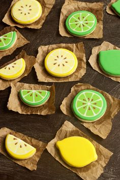 lemon and lime decorated cookies on brown paper