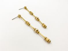 Tiny decorative brass beads feature in these fine, modern, long dangle earrings.  Simple, lightweight and minimalistic but with detail. Stainless steel earring post.  All Set Theory jewellery comes with care instructions and a polishing pad to keep it looking shiny and fabulous! ✨ Earrings measure 6.5 cms long 0.5 cms wide Gold Dainty Linear Earrings, Dainty Gold Linear Earrings, Gold Dainty Linear Metal Earrings, Modern Gold Long Drop Linear Earrings, Everyday Long Drop Brass Linear Earrings, Modern Yellow Gold Long Drop Threader Earrings, Modern Yellow Gold Threader Earrings, Minimalist Brass Drop Earrings, Minimalist Brass Linear Earrings With Long Drop