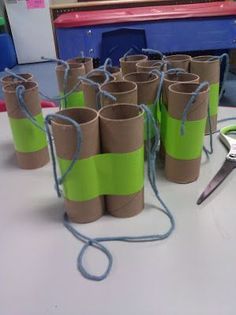 several rolls of toilet paper are tied up and ready to be used as vases