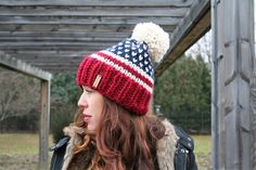 a woman wearing a red, white and blue knitted hat