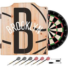 a wooden box with darts and darts in front of it that says brooklyn on the side