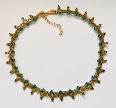 Crystal Glass Beaded Necklace Stunning handcrafted design A vintage style beaded necklace In a Gold & teal sparkling theme Perfect for weddings,parties & glamorous nights out     Intricate hand woven design     6mm teal AB faceted glass crystal rondelle beads     11/0 gold lined glass seed beads     11/0  green glass seed beads     Lobster clasp fastening     Extension Chain     16" plus extension     Complete with organza gift pouch Happy to alter length on request CONTACT - If you wish to cont Adjustable Beaded Emerald Necklace In Elegant Style, Elegant Adjustable Beaded Emerald Necklace, Adjustable Gold Beaded Necklaces With Bead Caps, Turquoise Spacer Beads Jewelry For Party, Gold Beaded Necklaces With Bead Caps For Gift, Gift Gold Beaded Necklaces With Bead Caps, Elegant Turquoise Beaded Emerald Necklace, Elegant Gold Beaded Emerald Necklace, Green Necklaces With Lobster Clasp For Party