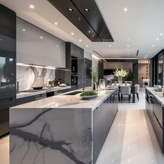 a large kitchen with marble counter tops and black cabinets