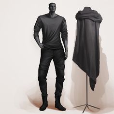 a mannequin standing next to a black cloth draped over his head and wearing boots