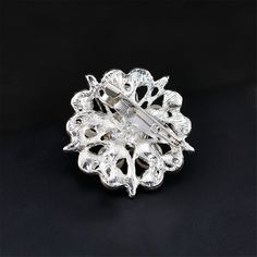 Refresh your accessory assortment with this brooch showcasing a delightful silhouette highlighted by glowing cubic zirconia embellishments. 1.18'' W x 1.85'' H Chain: 3.74'' L Silver plated copper / cubic zirconia / imitation pearl Elegant Silver Crystal Pins, Crystal Brooch Pins As Gift, Crystal Brooch Pins For Gifts, Formal White Crystal Brooches, Silver Crystal Brooch Pin, White Crystal Brooch For Formal Occasions, Elegant Round Crystal Brooches, White Crystal Brooch For Anniversary, Crystal Round Brooch For Party