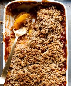 a casserole dish filled with fruit and crumbled toppings, ready to be eaten