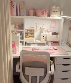 a white desk topped with a computer keyboard and mouse next to a shelf filled with drawers