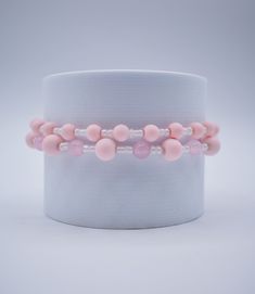 Faux baby pink pearl and glass beads make up this elastic band bracelet set! Pink Spacer Beads Bracelets For Party, Pink Party Bracelets With Spacer Beads, Pink Beaded Bracelets For Gift, Feminine Adjustable Bracelets With Round Beads, Pink Flexible Beaded Bracelets For Gifts, Pink Pearl Beaded Bracelets For Parties, Pink Beaded Stretch Bracelet For Party, Pink Beaded Party Bracelets, Adjustable Feminine Pearl Beaded Bracelets