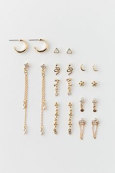 Set of 10 pairs of earrings - wear them as pairs or mix & match them for a one-of-a-kind earring stack look. Includes hoops and post earrings. Features Celestial rhinestone post & hoop earrings set Earrings set with rhinestone embellishments Set of ten pairs Includes studs, chains, dangle and hoop earrings Gold metal Post backings Content + Care Set of 10 pairs Mixed metal, glass Avoid contact with water Imported | Celestial Rhinestone Post & Hoop Earring Set in Gold, Women's at Urban Outfitters Hoop Earring Set, Earring Stack, Metal Post, Set Earrings, Hoop Earrings Gold, Rhinestone Embellishments, Hoop Earring Sets, Women Accessories Jewelry, Earrings Set