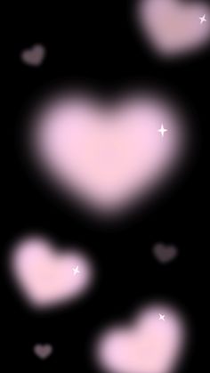 some pink hearts on a black background with white stars and the shape of a heart