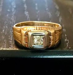 A 14kt yellow gold antique old European cut diamond ring.  Size 7 1/8. Diamond bead set in white gold.   Condition is good for its age-wear commensurate with age.  THE DIAMOND is an old EUROPEAN or miner cut diamond-the diamond faceting is good there is a bit of a typical inclusion(carbon)-not noticeable when worn only mentioned for accuracy.  It has a Deco styled shank with some wear from age but -smooth wear commensurate with its age.  Circa first half of the 1900s.  Easy statement ring to wea Vintage White Gold Signet Ring Stamped 14k, Classic Diamond Signet Ring Collectible, Collectible Classic Diamond Signet Ring, Vintage Yellow Gold Rings With Diamond Accents, Vintage 14k Gold Diamond-cut Signet Ring, Classic Diamond White 14k Stamped Signet Ring, Vintage 14k Gold Diamond Cut Signet Ring, Vintage 14k Gold Signet Ring With Diamond Cut, Vintage Yellow Gold Signet Ring With Single Diamond