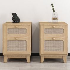 two wooden nightstands side by side with one holding a phone and the other has a plant on top