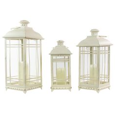 three white lanterns sitting next to each other