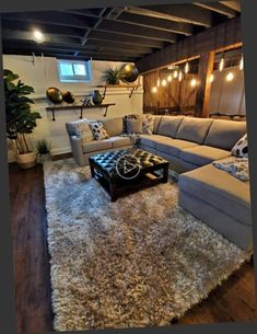 a living room filled with furniture and lights on the wall above it's windows