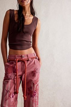 So unique from our We The Free collection, these embroidered pants add an elevated touch to every outfit. **Fit:** Low-rise, cropped length **Features:** Zip-fly and button closure, adjustable belt at waistband, embroidered floral detailing, welt pockets at back, cuffed legs **Why We ❤ It:** These one-of-a-kind pants are the perfect pair for any warm weather occasion. | We The Free Electric Sands Embroidered Pants at Free People in Brown, Size: US 6 Free People Crop, Vintage Runway Fashion, Embroidered Trousers, Vintage Runway, Embroidered Pants, Free People Style, All Jeans, Boho Casual, Adjustable Belt