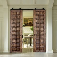 an open wooden door leading to a dining room