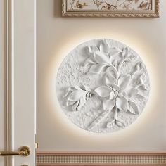 a white circular wall decoration with flowers on it