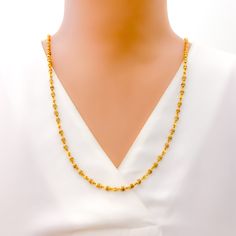 This luxurious necklace is skillfully crafted with 22k gold, totaling 11.8 grams, with 11.0 grams in gold and 0.8 grams in Tulsi beads. It showcases a radiant yellow gold finish and measures 26 inches in length, seamlessly designed without a lock for uninterrupted elegance. The subtle inclusion of Tulsi beads adds a touch of spiritual significance, making this piece not only a fashion statement but also a nod to cultural heritage. Ideal for those seeking jewelry that blends sophistication with m Traditional 22k Gold Necklace With Delicate Chain, Elegant Yellow Necklace For Puja, 22k Gold Jewelry With Delicate Chain, Elegant Yellow Gold Necklace For Puja, Gold Necklaces With Tilla Detailing In 22k Gold, 22k Gold Necklaces With Tilla Detailing, 22k Gold Necklace With Tilla, Gold Necklaces With Tilla Detailing, Gold Plated Temple Necklace With Tilla