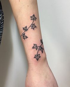 a woman's arm with an origami tattoo on it