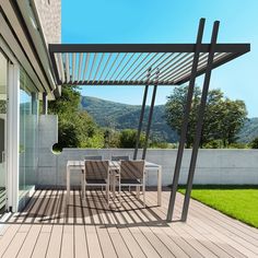 an outdoor patio with wooden flooring and white walls