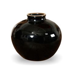 a black vase is shown on a white background