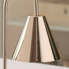 a metal lamp on a white counter top