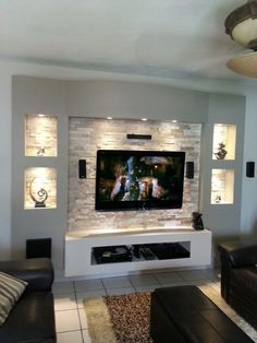 a large flat screen tv mounted to the side of a wall in a living room