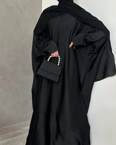 *FALL 2023 COLLECTION* Welcome to our most versatile abaya from our whole entire collections. This fully closed Farasha (butterfly cut) abaya is made of a very lightweight yet durable fabric, that will keep you cool in those warmer days. The best abaya to wear during Umrah or Hajj as the fabric is lightweight and does not retain heat. It's very versatile and can be worn while running errands or even styling it up for a more formal event. The model is 1.80 m and wears size 58'. Abaya Material: Lightweight Washed Silk Fabric. Scarf Material: 100% High Quality Laser Chiffon Care instructions: Dry Cleaning Recommended Black Long Sleeve Khimar With Dabka, Long Black Modest Khimar, Black Long Abaya, Evening Solid Color Maxi Length Abaya, Evening Solid Maxi Length Abaya, Evening Maxi Length Solid Abaya, Elegant Black Maxi Khimar, Eid Evening Solid Color Abaya, Elegant Black Maxi Length Khimar