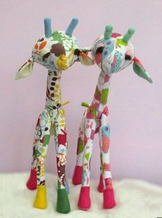 two stuffed giraffes standing next to each other