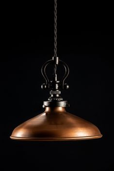 a large metal light hanging from a ceiling