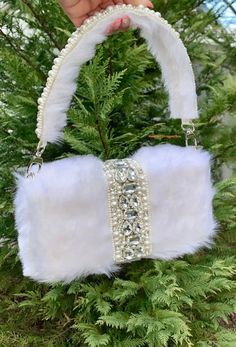 My personal guilty pleasure is handbags so let's keep calm and collect handbags.  Handmade faux fur fabric bag for your special next event.  A very glamorous piece with a chic touch. This statement piece is embellished with a rhinestones/pears border in middle and finished off with pearl embellished handle. Dimensions  Height approximately 4 1/2 inches (bag it self) Length approximately 8 inches (bag it self) Width approximately 2 1/4 inches (bag it self)  Bag it self means, not including the faux fur dimensions around the bag.   Strap length approximately from center to bag 7 inches Strap width approximately 1 1/4 inches Color, shades, texture displayed may slightly vary from the actual product due to digital image limitations. Care: It is advisable that you keep our products away from di Handbags Handmade, Posh Style, Fur Fabric, Wedding Bag, Faux Fur Fabric, Guilty Pleasure, Accessories Bags Purses, Box Bag, Bridal Pearls