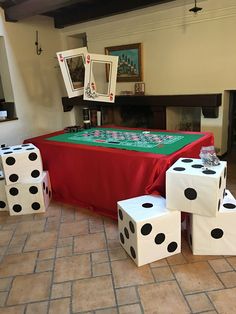 a table with dices on it in front of a fireplace