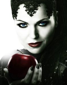 a woman with blue eyes holding an apple