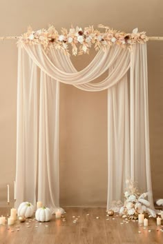 a wedding arch decorated with flowers and candles