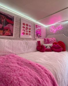 a bedroom with pink and white decor on the walls