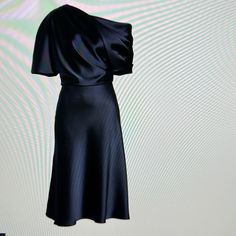 a black dress is on display in front of a white background