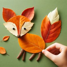 someone is making a paper fox out of leaves