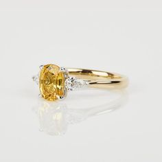 - Centre stone: Sapphire- Shape | Cut: Oval - Carat weight: 1.45ct- Dimension: 7.55 x 5.70mm- Colour:  Canary YellowSetting:- 18k Yellow and White Gold - 2mm Band- Pair of matching pear shape side diamonds, weighing a total of 0.28ct * All of the diamonds we use are conflict-free and the gold is recycled.All of our jewellery is designed and hand made by sister and brother, Sophia & Daniel, in their London workshop. As each ring is handmade, please allow 2-3 weeks from start to finish and rec Yellow Sapphire Engagement Ring, Yellow Sapphire Ring Engagement, Trilogy Engagement Ring, Sister And Brother, Ring Bearer Gifts, Yellow Sapphire Rings, Three Stone Engagement Ring, Yellow Rings, Vintage Style Rings