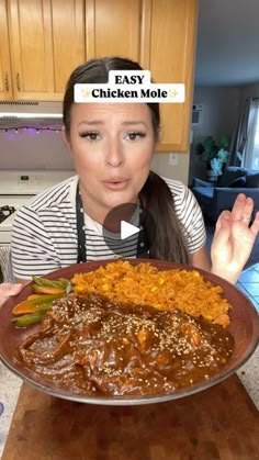 a woman is holding a plate with food on it and the words fast chicken molee above her head