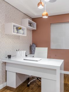 a white desk in the corner of a room