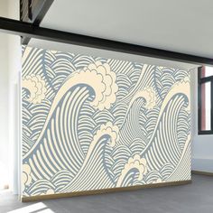 a large wall mural in an empty room with the ocean waves painted on it's side