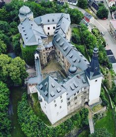 an aerial view of a castle surrounded by trees