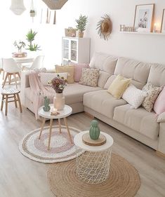 a living room filled with lots of furniture and decor on top of hard wood floors