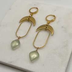 Unique Gold Jade Earrings, Gold Chalcedony Dangle Earrings, Green Dangle Jewelry With Moon Charm, Teardrop Brass Earrings With Moon Charm, Brass Teardrop Earrings With Moon Charm, Handmade Gold Earrings With Chalcedony, Green Hand Forged Brass Earrings, Gold Moon Shaped Wire Wrapped Earrings, The Hook